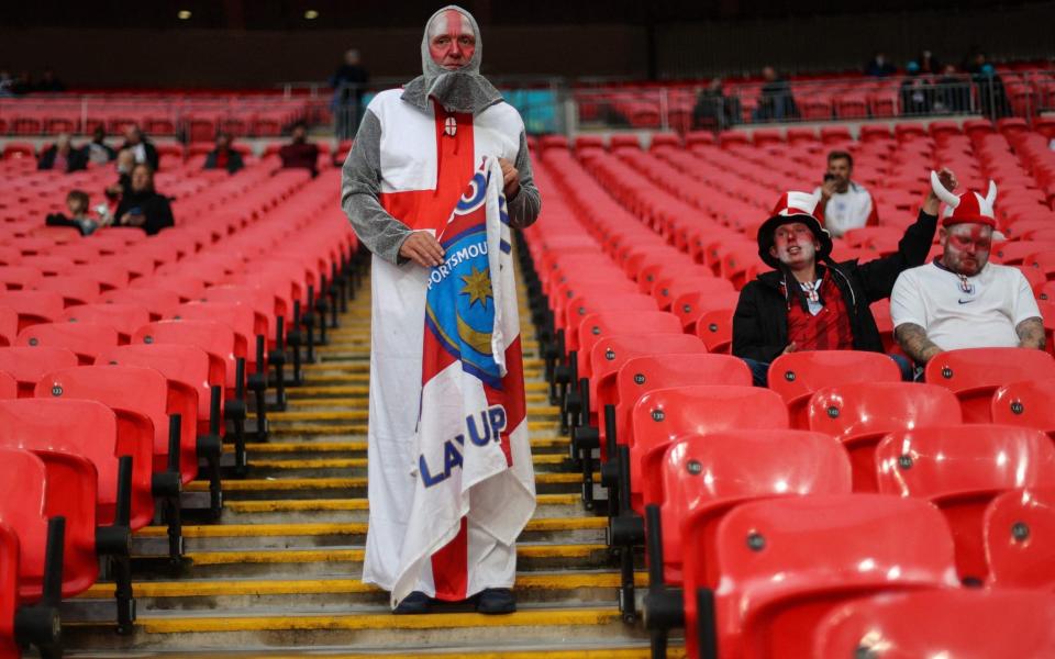 An England fan arrives prior to the UEFA EURO 2020 Group D football match between England and Scotland at Wembley Stadium in London on June 18, 2021. (Photo by Carl Recine / POOL / AFP) (Photo by CARL RECINE/POOL/AFP via Getty Images)  - Carl Recine/AFP