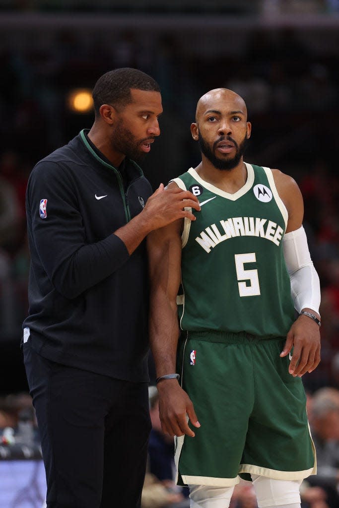 Bucks associate head coach Charles Lee talks with guard Jevon Carter against the Bulls during the second half of a preseason game at United Center on October 11, 2022 in Chicago.