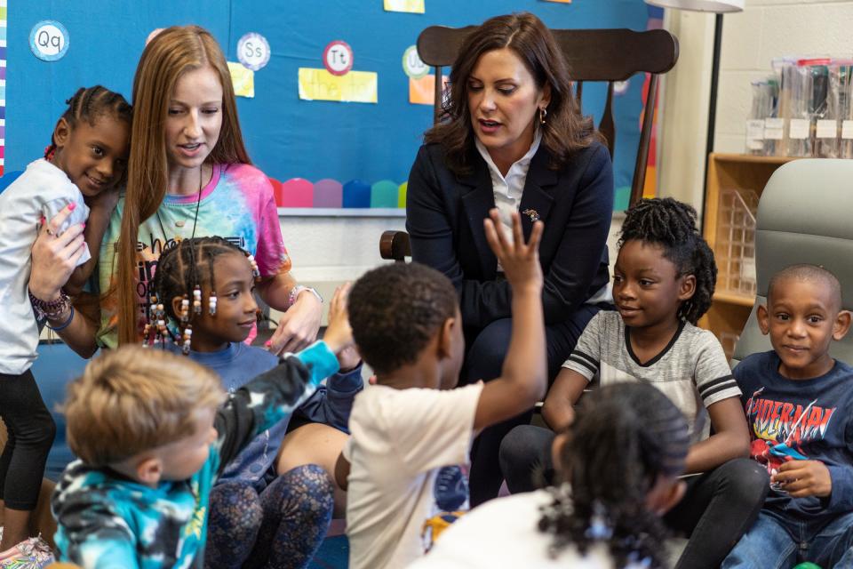 Michigan Gov. Gretchen Whitmer gives fives after taking a photo with first grade students after stopping in their classroom during a visit at Forest Park Elementary in Eastpointe on Monday, Aug. 28, 2023.