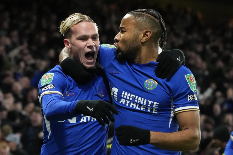 Chelsea's Mykhailo Mudryk, left, celebrates with teammate Chelsea's Christopher Nkunku after scoring his sides first goal of the game during the English League Cup quarterfinal soccer match between Chelsea and Newcastle United at Stamford Bridge in London, Tuesday, Dec. 19, 2023. (AP Photo/Kirsty Wigglesworth)