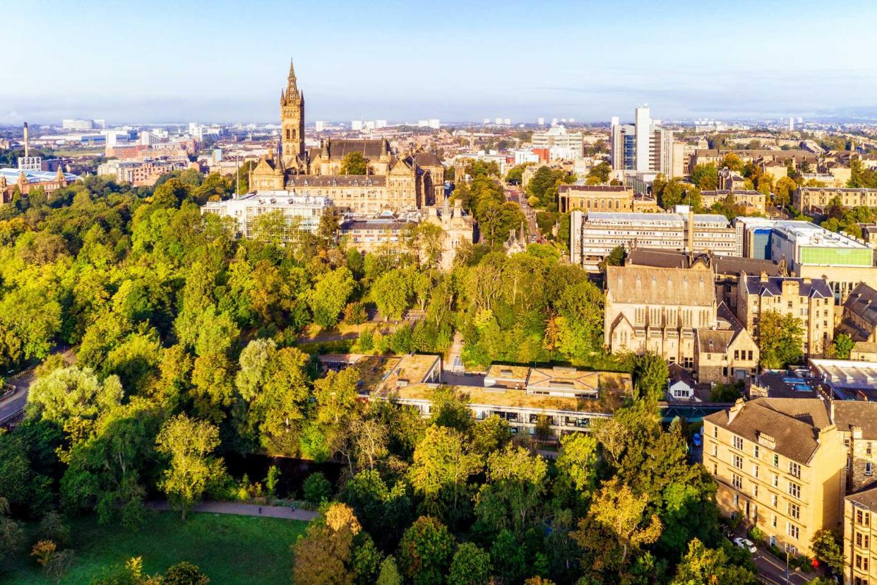 An aerial view of part of Glasgow's West End, including the trees of Kelvingrove Park and several Glasgow University buildings.