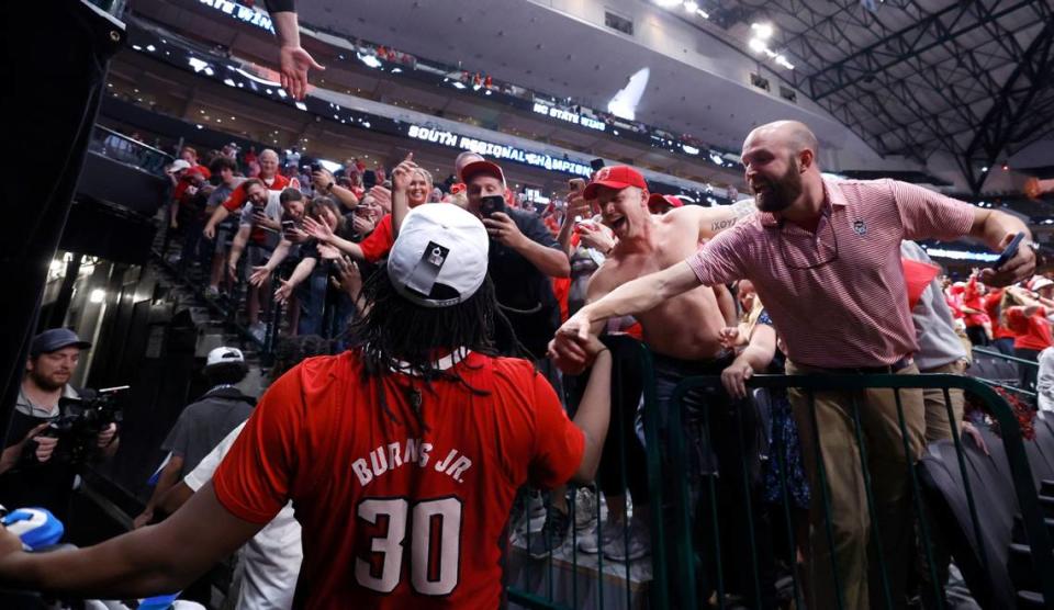 Fans congratulate N.C. State’s DJ Burns Jr. (30) as he walks off the court after the Wolfpack’s 76-64 victory over Duke in their NCAA Tournament Elite Eight matchup at the American Airlines Center in Dallas, Texas, Sunday, March 31, 2024.