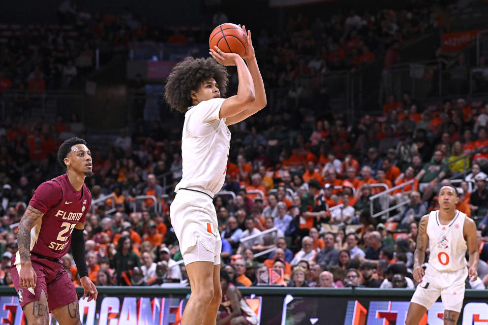 CORAL GABLES, FL - JANUARY 17: Miami guard Kyshawn George (7) shoots a jump shot in the first half (also pictured, Miami guard Matthew Cleveland (0), FSU guard Primo Spears (23)) as the Miami Hurricanes faced the Florida State Seminoles on January 17, 2024, at the Watsco Center in Coral Gables, Florida. (Photo by Samuel Lewis/Icon Sportswire via Getty Images)