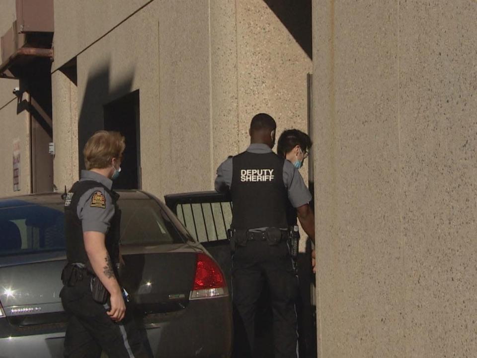 Dillon &#39;Ricky&#39; Whitehawk is brought into the Delta Hotel in Regina. The Whitehawk murder trial is being held at the Delta Hotel to allow for physical distancing due to the COVID-19 pandemic.  (CBC News - image credit)