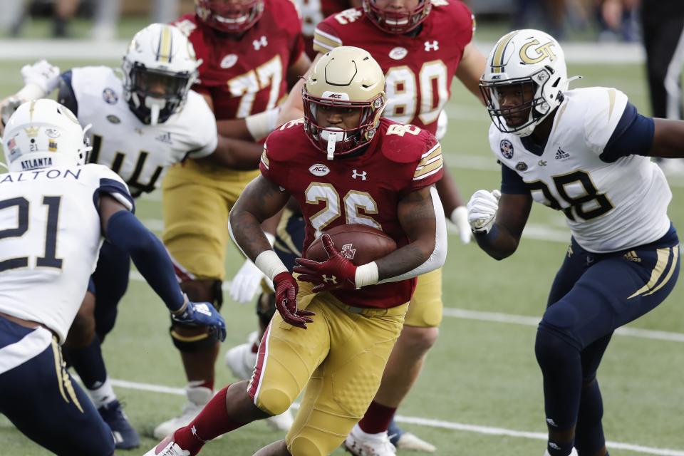 Boston College running back David Bailey (26) carries the ball against Georgia Tech defensive back Zamari Walton (21) and defensive lineman Curtis Ryans, right, during the first half of an NCAA college football game Saturday, Oct. 24, 2020, in Boston. (AP Photo/Michael Dwyer)