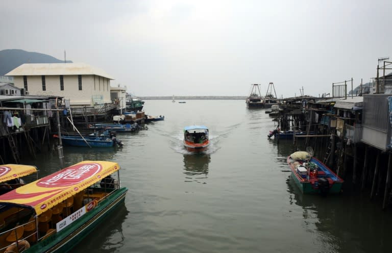 A tour boat (C) returns after a trip to see the famous pink dolphins in the waters around Tai O in Hong Kong