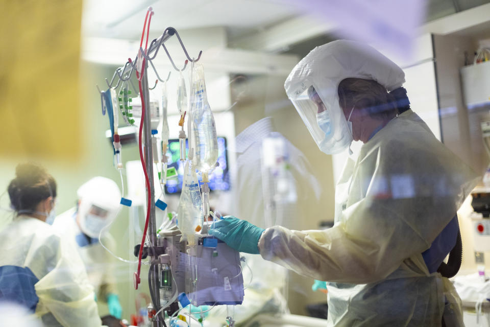 Jack Kingsley R.N. attends to a COVID-19 patient in the Medical Intensive care unit (MICU) at St. Luke's Boise Medical Center in Boise, Idaho on Tuesday, Aug. 31, 2021. St. Luke's Health System announced on Tuesday that it will pause certain elective surgeries and procedures starting Sept. 1 because of increasing COVID-19 cases in Idaho. (AP Photo/Kyle Green)