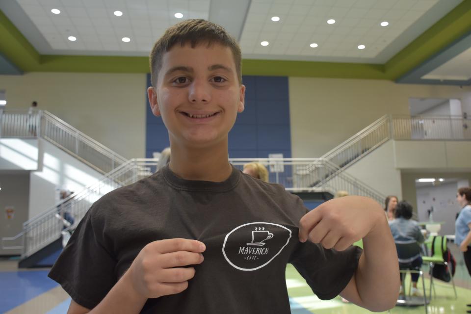 Mill Creek Middle School student Landon Gehring wore his Maverick Café shirt to school on Friday, May 20, 2022. Gehring helped start the in-school café with his mom and teachers where special education and general education students work together to serve teachers on Friday mornings.