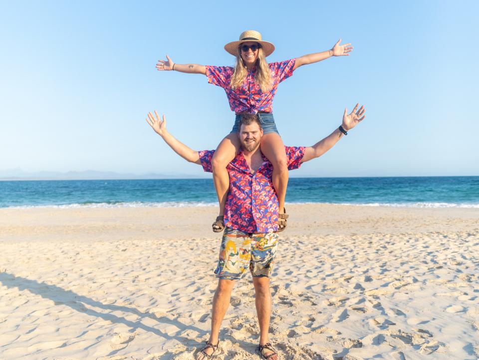 A couple wearing matching clothes on a beach.