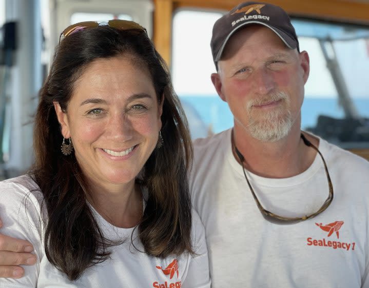 Cristina Mittermeiter and Paul Nicklen pose fo a photo on a ship.