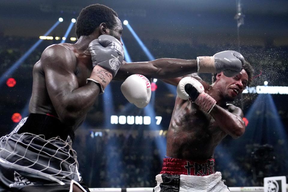 Terence Crawford hits Errol Spence Jr. and sweat flies off him during their boxing match