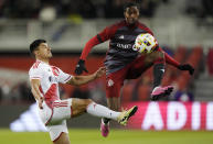 Toronto FC's Tyrese Spicer, right, controls the ball as New England Revolution's Nick Lima defends during the second half of an MLS soccer match Saturday, April 20, 2024, in Toronto. (Frank Gunn/The Canadian Press via AP)