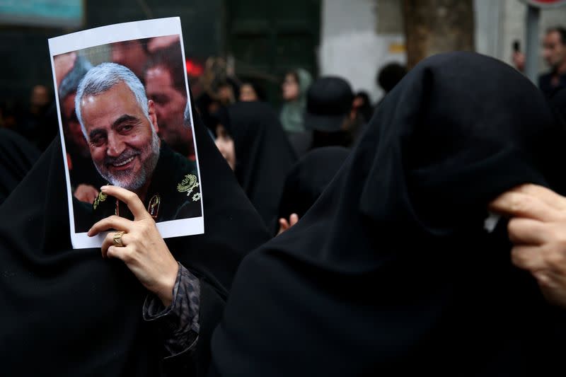Iranian women react as they gather to mourn General Qassem Soleimani in Tehran