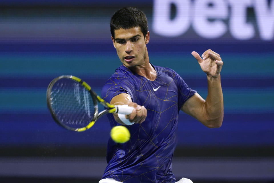 Carlos Alcaraz, of Spain, hits a return to Hubert Hurkacz, of Poland, during the Miami Open tennis tournament Friday, April 1, 2022, in Miami Gardens, Fla. (AP Photo/Marta Lavandier)