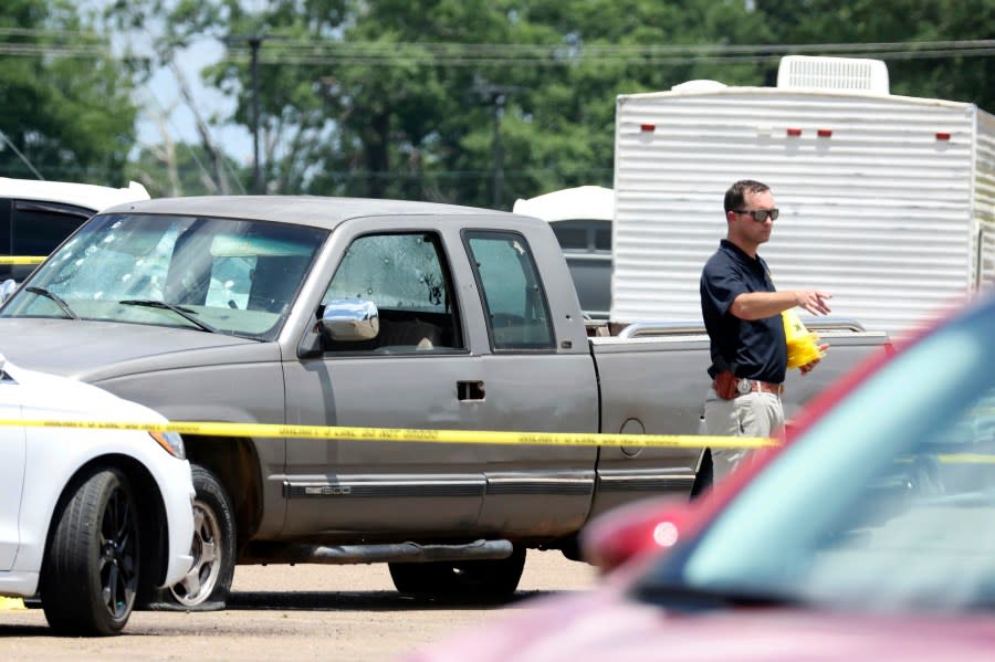 Law enforcement officers work the scene of a shooting at the Mad Butcher grocery store in Fordyce, Ark., Friday, June 21, 2024. (Colin Murphey/Arkansas Democrat-Gazette via AP)