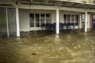 Seawater from crashing waves cover the yard of a tavern during a storm at the port of Argostoli, on the Ionian island of Kefalonia, western Greece, Friday, Sept. 18, 2020. Hurricane-force winds and heavy rainfall battered several islands off the western coast of Greece Friday, causing power outages and road closures, as authorities in nearby mainland areas remained on alert. (AP Photo/Nikiforos Stamenis)