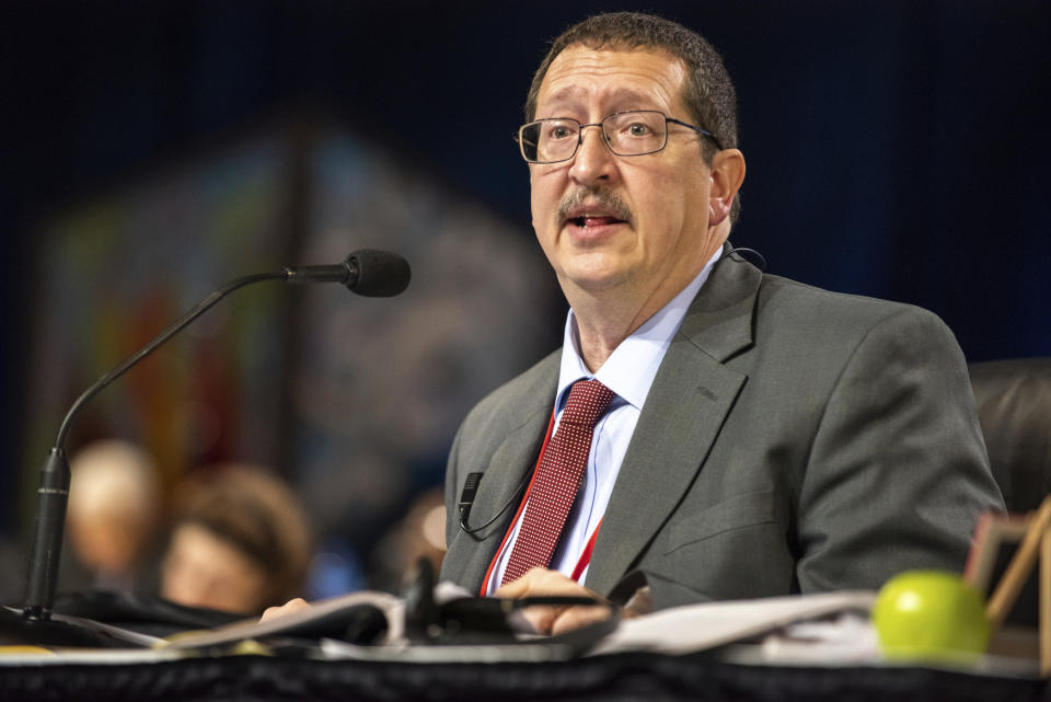 The Rev. Gary Graves, secretary of the General Conference, moderates a discussion during the 2019 Special Session of the General Conference of The United Methodist Church in St. Louis, Mo., Tuesday, Feb. 26, 2019. America's second-largest Protestant denomination faces a likely fracture as delegates at the crucial meeting move to strengthen bans on same-sex marriage and ordination of LGBT clergy. (AP Photo/Sid Hastings)