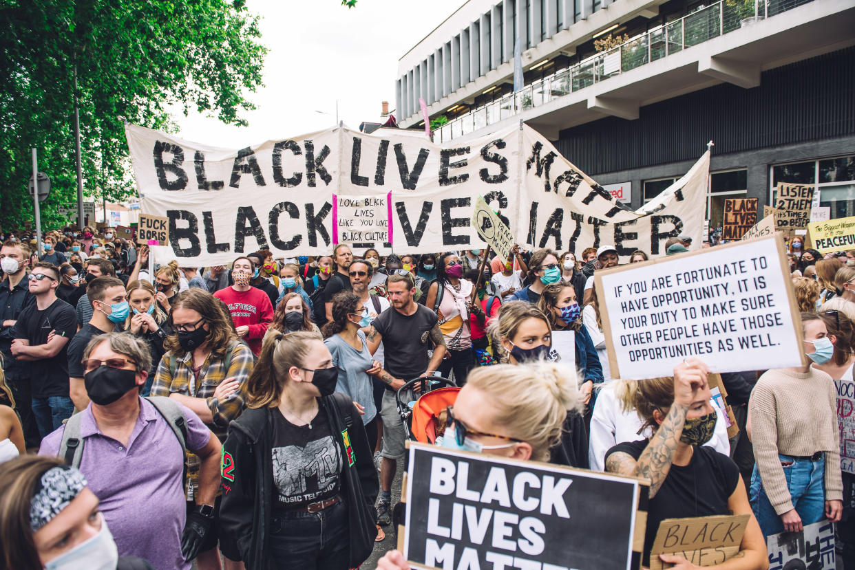 Crowd marches in front of Colston Hall, concert venue dedicated to Edward Colston, a slave trader who lived in the 17th century and played a major role in the development of the city of Bristol, England, on June 7, 2020. (Photo by Giulia Spadafora/NurPhoto via Getty Images)