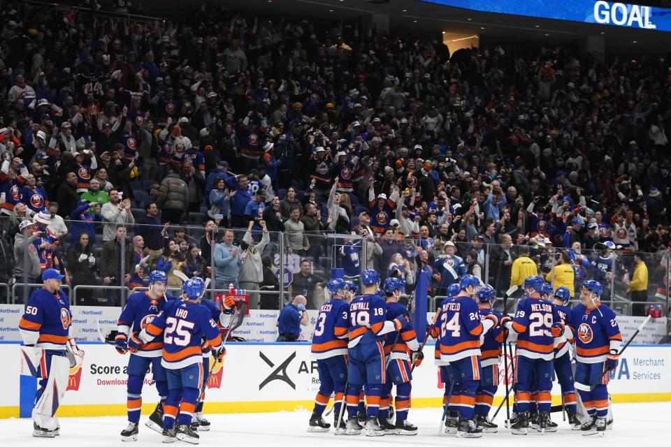 The New York Islanders celebrate after Mathew Barzal scored the winning goal during the overtime period of an NHL hockey game against the Toronto Maple Leafs, Thursday, Jan. 11, 2024, in Elmont, N.Y. (AP Photo/Frank Franklin II)