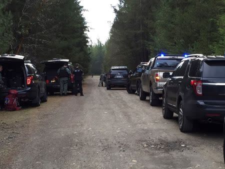 Police vehicles line the road near a rural property near Belfair, Washington, February 26, 2016 in this handout photo provided by Mason County Sheriff's Office in Shelton, Washington. REUTERS/Mason County Sheriff's Office/Handout via Reuters