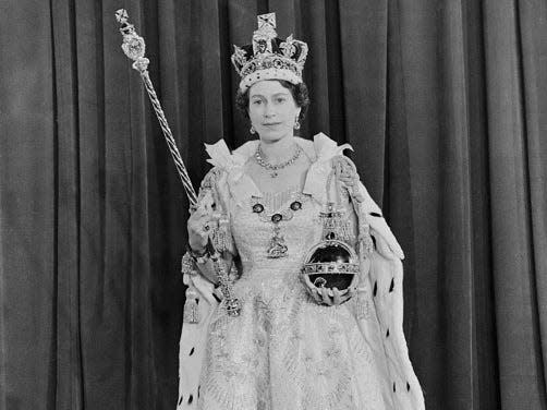 The queen in her dress, holding the orb and sceptre.