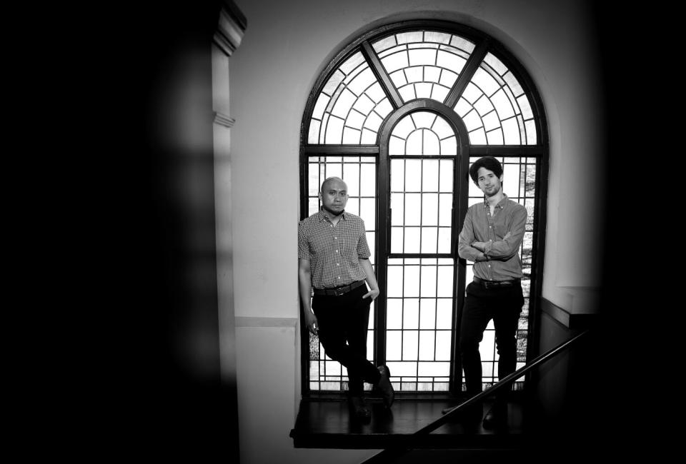 Paulo K Tiról and Noam Shapiro stand by a theater window.