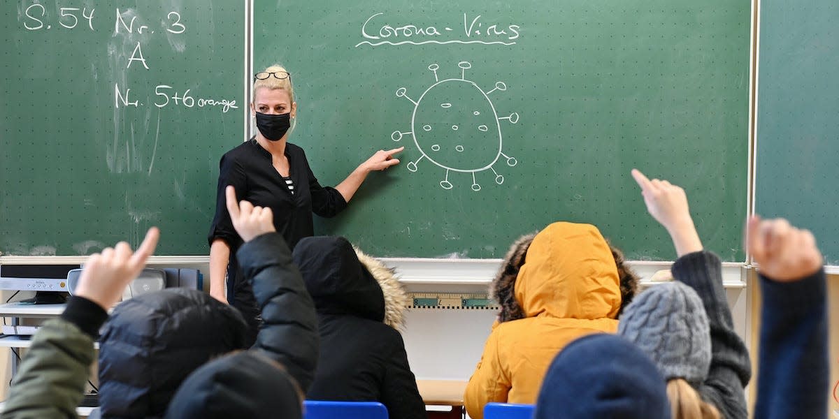 A school teacher in Osterode, Germany, teaches students aboout the coronavirus.
