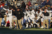 Wake Forest players and coaches celebrate their win over Boston College as time expires in the second half of an NCAA college football game, Saturday, Nov. 27, 2021, in Boston. (AP Photo/Mary Schwalm)