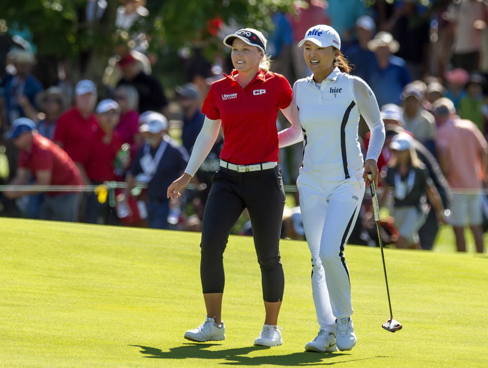 Jin Young Ko of South Korea walks up the eighteenth fairway with Brooke Henderson of Canada on her way to winning the CP Women's Open in Aurora, Ontario, Sunday, Aug. 25, 2019. (Frank Gunn/The Canadian Press via AP)