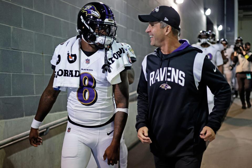 Baltimore Ravens quarterback Lamar Jackson (8) and John Harbaugh takes the field to face the New York Giants during an NFL football game, in East Rutherford, N.J Ravens Giants Football, East Rutherford, United States - 16 Oct 2022