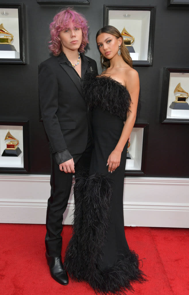 Kid in a suit and Katarina in a long, straight, strapless gown