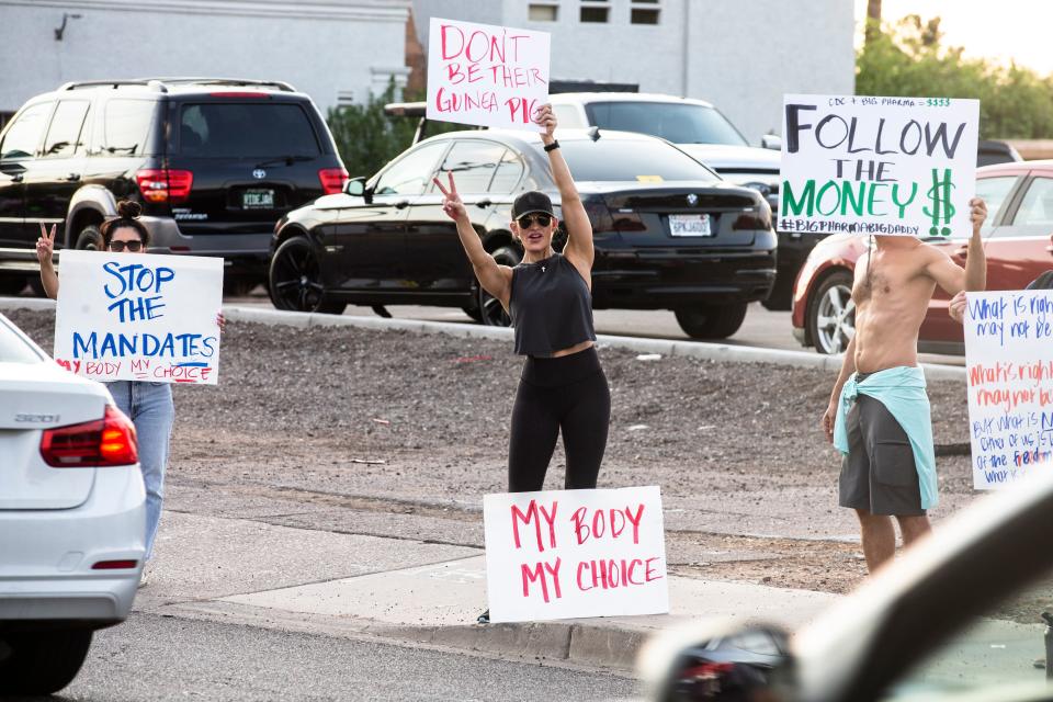 Individuals gather to protest vaccine mandates across the street from the Phoenix Children's Hospital in Phoenix, Aug. 13, 2021. Benjamin Chambers/The Republic