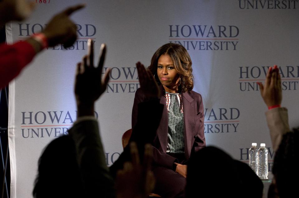 First lady Michelle Obama watches as hands shoot up during a town hall meeting at Howard University in Washington, Thursday April 17, 2014 . The first lady joined juniors and seniors from Chicago public high schools on the first day of their four-day visit to Howard University, as part of a program to immerse talented high school students in a college campus environment. (AP Photo/Jacquelyn Martin)