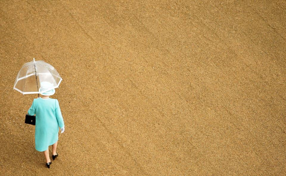 <p>Rain hits the Queen’s Royal Garden Party at Buckingham Palace. (PA) </p>