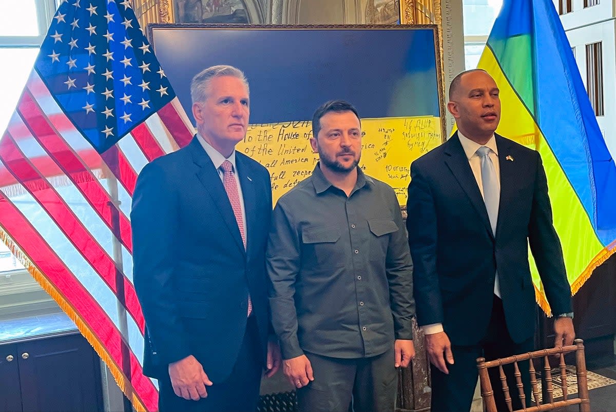 Ukrainian president Volodymyr Zelensky (centre) poses for a photo with House speaker Kevin McCarthy (left) and Hakeem Jeffries at a closed-door meeting with members of Congress on Capitol Hill in Washington (AP)