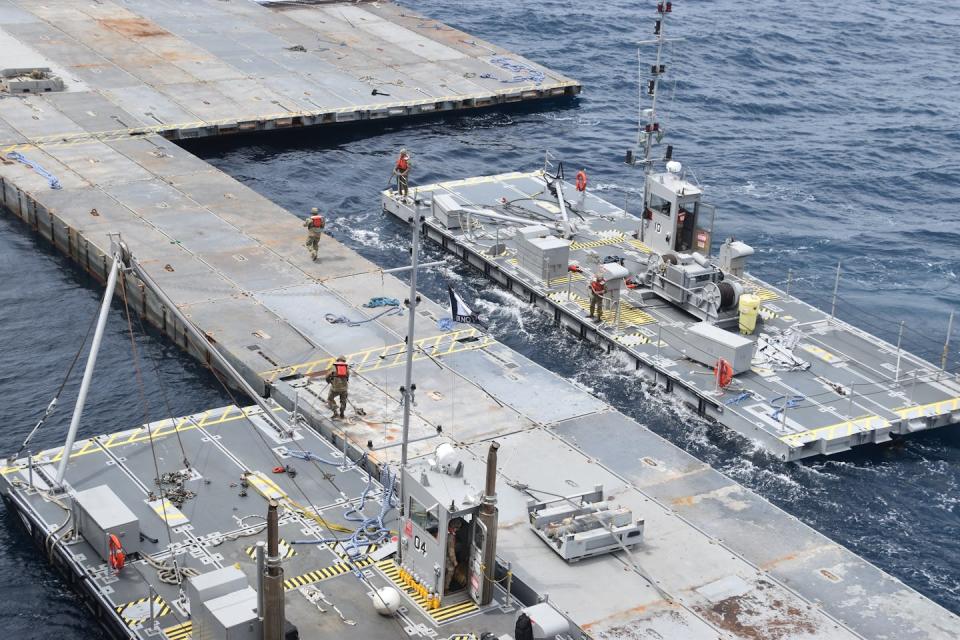 U.S. troops assemble floating barges into larger structures as part of the construction of the floating pier off Gaza. <a href="https://newsroom.ap.org/detail/IsraelPalestiniansAidPort/c5be90242b7649aca4c0e81c84855285/photo" rel="nofollow noopener" target="_blank" data-ylk="slk:U.S. Army via AP;elm:context_link;itc:0;sec:content-canvas" class="link ">U.S. Army via AP</a>