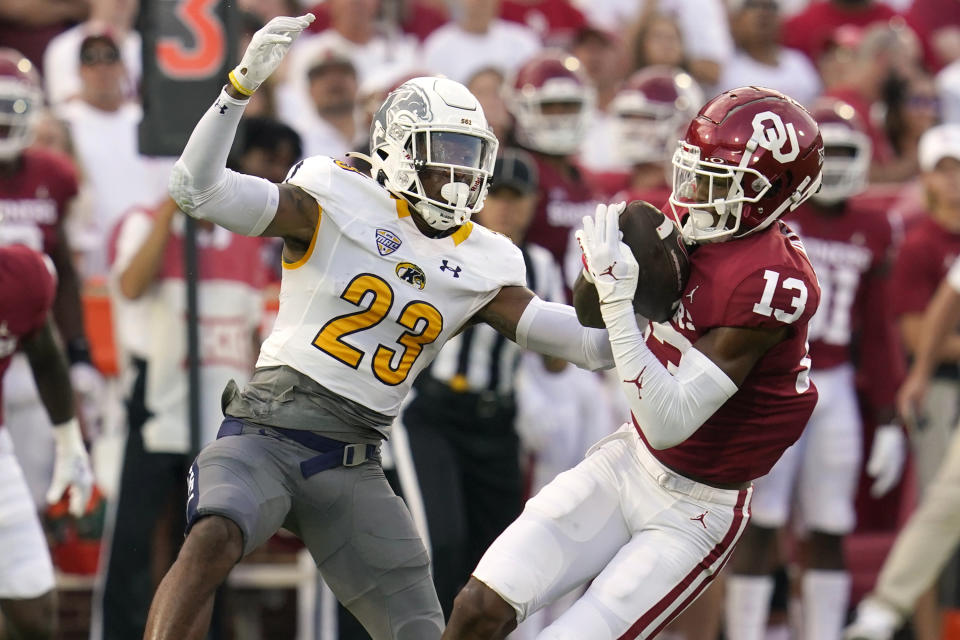 Oklahoma wide receiver J.J. Hester (13) catches a pass in front of Kent State safety JoJo Evans (23) in the first half of an NCAA college football game, Saturday, Sept. 10, 2022, in Norman, Okla. (AP Photo/Sue Ogrocki)