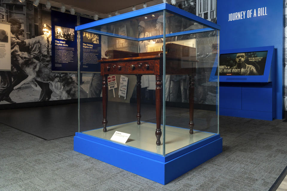The desk on display at the LBJ Presidential Library, that President Lyndon B. Johnson sat at in the President's Room at the U.S. Capitol to sign the Voting Rights Act of 1965, on Aug. 6, 1965, is seen on May 16, 2023. (AP Photo/Stephen Spillman)