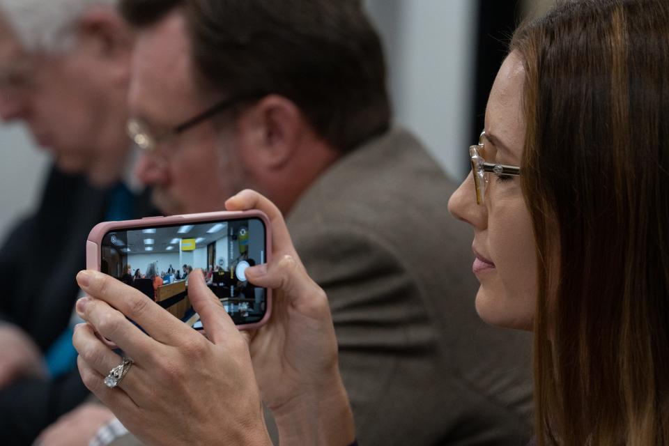 Ann Atkinson takes a photo during a Freedom of Expression Committee hearing on July 18, 2023, in a Senate Hearing room at the Arizona State Capital in Phoenix.