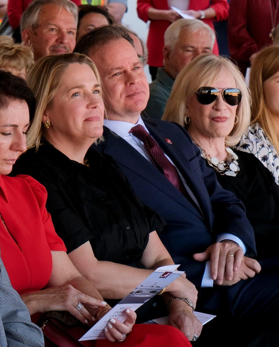 Members of the Smith family, from left, Cameron, Clay and Linda Smith, listen to speakers during the groundbreaking for the Smith Family Center For The Performing Arts at the University of Alabama Friday, Oct. 20, 2023.
