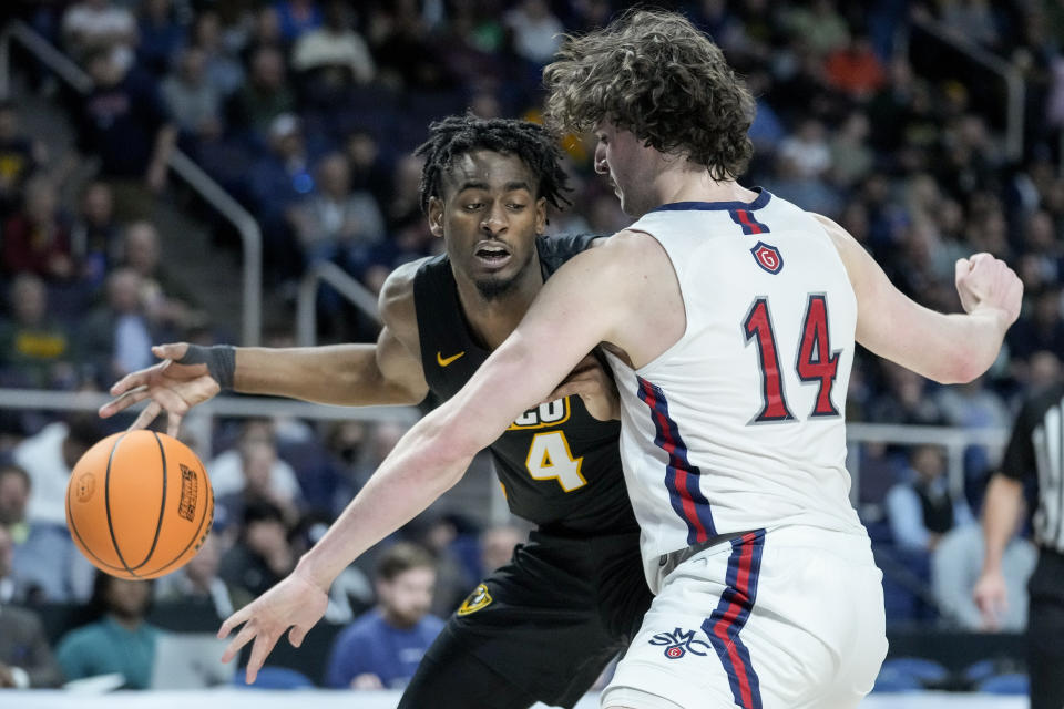 Virginia Commonwealth's Jalen DeLoach (4) drives against St. Mary's Kyle Bowen (14) in the first half of a first-round college basketball game in the NCAA Tournament, Friday, March 17, 2023, in Albany, N.Y. (AP Photo/John Minchillo)