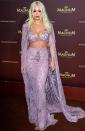 Rita has a mermaid moment at the Magnum x Rita Ora party in an embellished purple crop top, matching high-waisted skirt and cape (all Zuhair Murad couture), worn with long blonde locks.