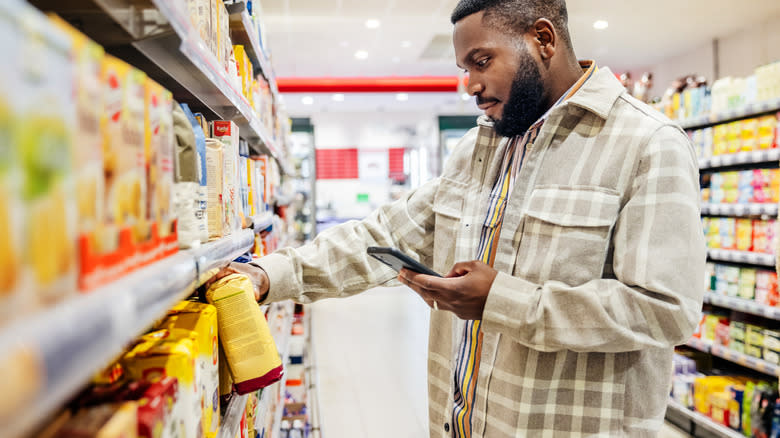 Man holding product in grocery store