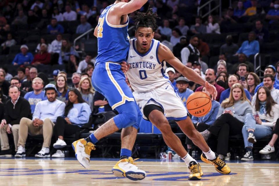 Kentucky forward Jacob Toppin (0) drives past UCLA guard Jaime Jaquez Jr. during the first half of an NCAA college basketball game in the CBS Sports Classic, Saturday, Dec. 17, 2022, in New York. (AP Photo/Julia Nikhinson)