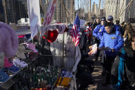 Police officers had out notices to vendors on the Brooklyn Bridge in New York, Tuesday, Jan. 2, 2024. The notices warn vendors that no more vending will be allowed on the bridge starting January 3, 2024. (AP Photo/Seth Wenig)