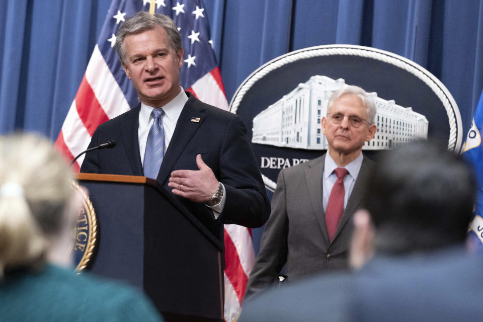 Federal Bureau of Investigation (FBI) Director Christopher Wray flanked by Attorney General Merrick Garland speaks during a news conference to announce an international ransomware enforcement action, at the Department of Justice in Washington, Thursday, Jan. 26, 2023. The FBI has seized the website of a prolific ransomware gang that has heavily targeted hospitals and other healthcare providers. (AP Photo/Jose Luis Magana)