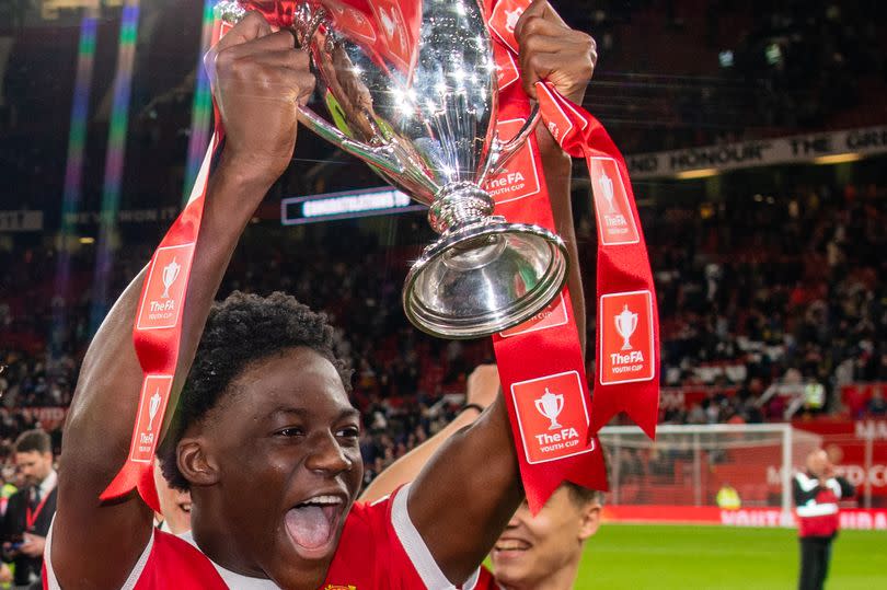 Kobbie Mainoo lifts the FA Youth Cup aloft in 2022.