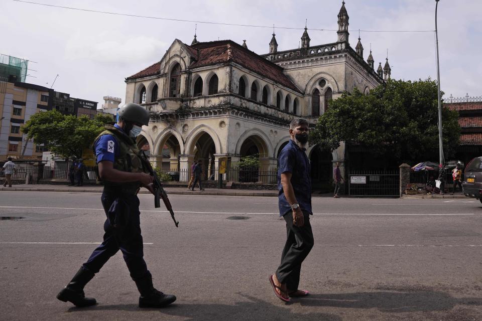 A Sri Lankan navy soldier patrols in a street during a relaxation in a nationwide curfew that began Monday evening in Colombo, Sri Lanka, Thursday, May 12, 2022. Sri Lanka's president on Wednesday promised to appoint a new prime minister, empower the Parliament and abolish the all-powerful executive presidential system as reforms to stabilize the country engulfed in a political crisis and violence triggered by the worst economic crises in memory.(AP Photo/Eranga Jayawardena)