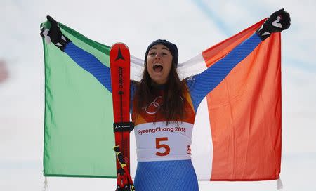 Alpine Skiing - Pyeongchang 2018 Winter Olympics - Women's Downhill - Jeongseon Alpine Centre - Pyeongchang, South Korea - February 21, 2018 - Gold medallist Sofia Goggia of Italy celebrates with the Italian flag during the flower ceremony. REUTERS/Leonhard Foeger