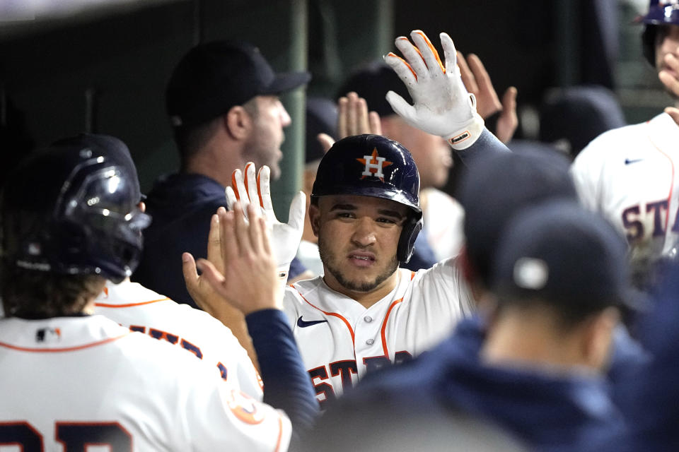 Houston Astros' Yainer Diaz celebrates in the dugout after hitting a two-run home run against the Baltimore Orioles during the sixth inning of a baseball game Tuesday, Sept. 19, 2023, in Houston. (AP Photo/David J. Phillip)